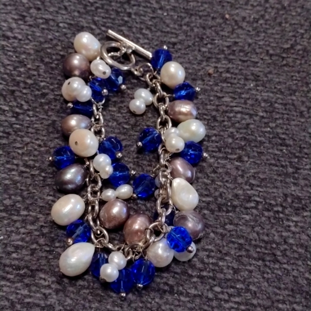 Freshwater pearl bracelet with blue beads.